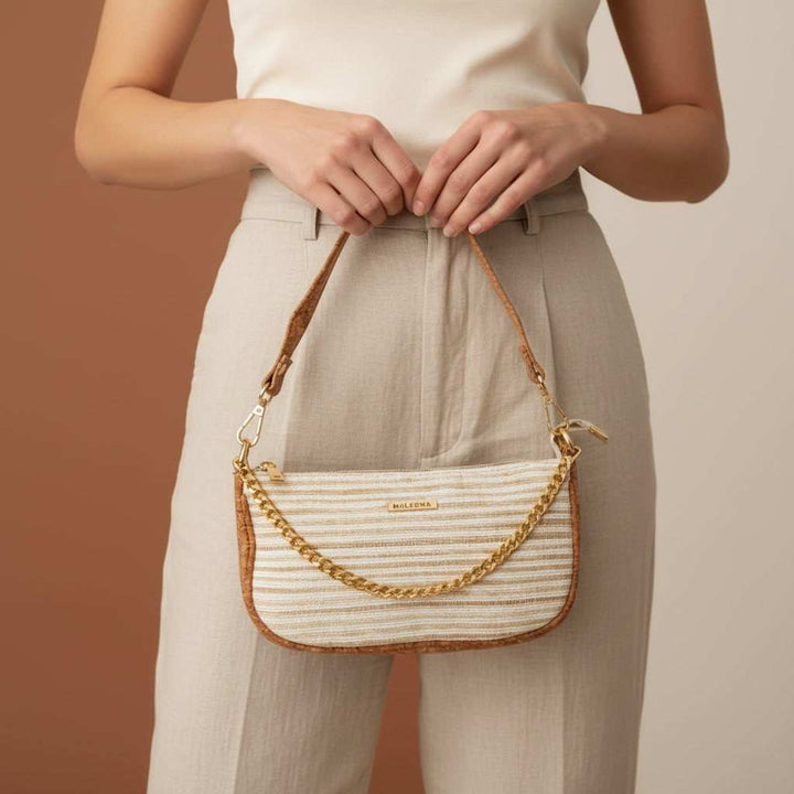 model is holding a eco friendly clutch bag 