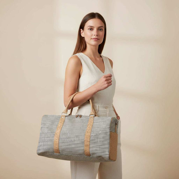 model holding a travel duffle bag